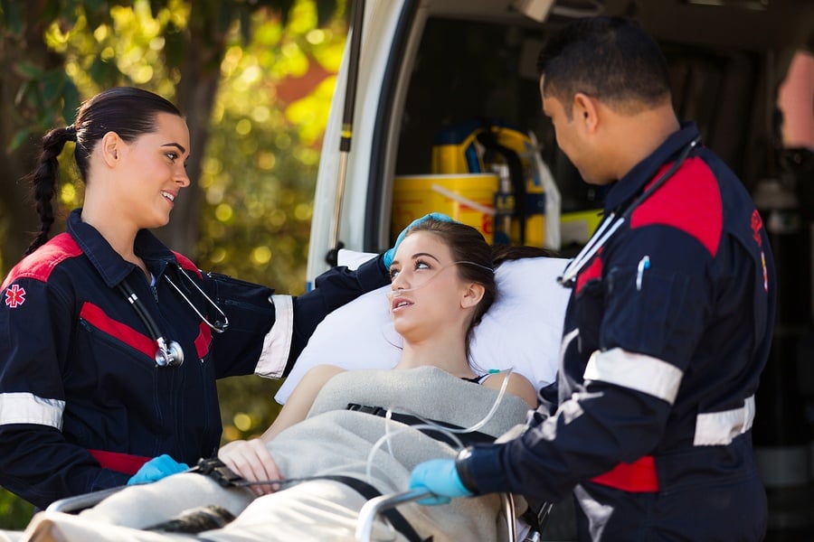 Paramedics with a patient on a gurney